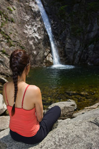 Woman sitting by a waterfall at seroksan national park