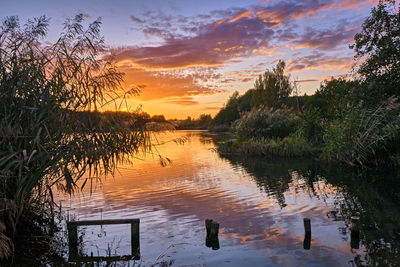 Scenic view of lake against sky during sunset