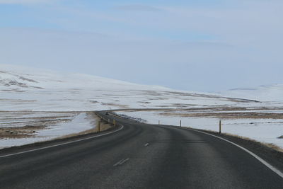 Empty road with mountain in background