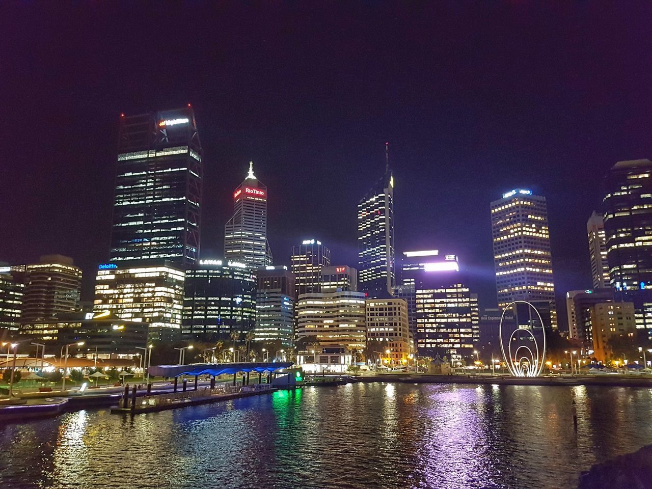 ILLUMINATED BUILDINGS IN CITY AT NIGHT