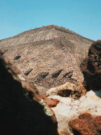 Low angle view of rocks against clear sky