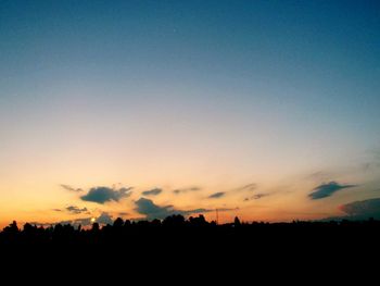 Silhouette trees against sky during sunset