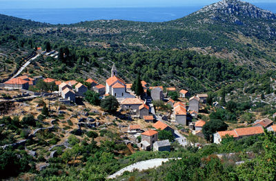 Houses on mountain against sky