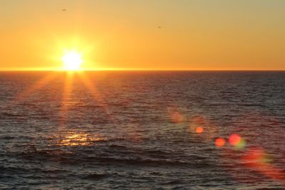 Scenic view of sea against clear sky during sunset