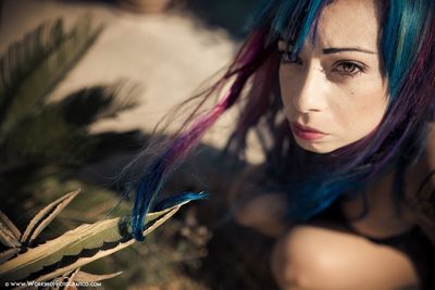 Close-up of young woman with peacock