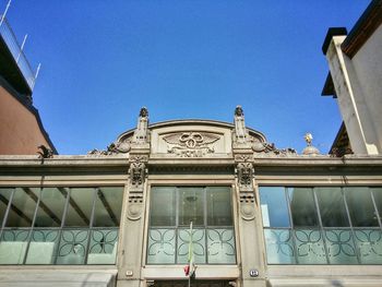 Low angle view of building against clear blue sky