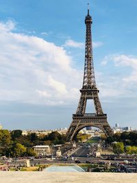 Eiffel tower in city against sky