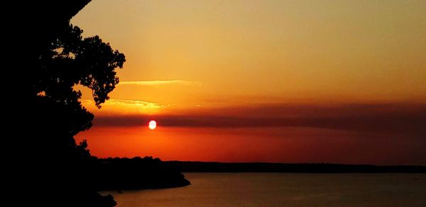 Scenic view of sea against romantic sky at sunset