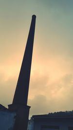 Low angle view of buildings against sky at sunset