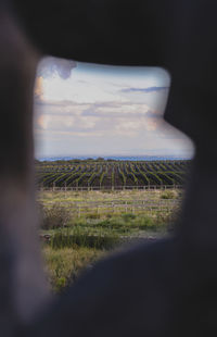 Scenic view of field against sky seen through car window