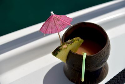 High angle view of cocktail in glass on railing