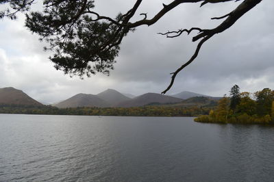 Idyllic shot of river and mountains against cloudy sky