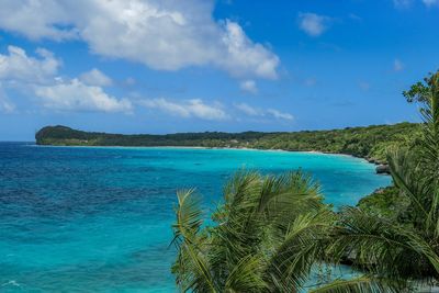 Scenic view of turquoise sea against blue sky