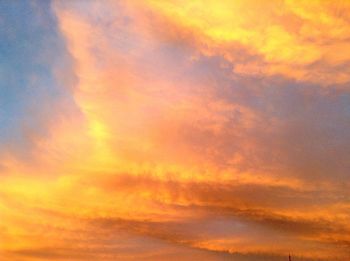 Low angle view of cloudy sky at sunset