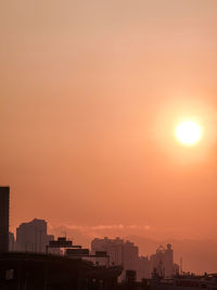 Silhouette buildings against sky during sunset