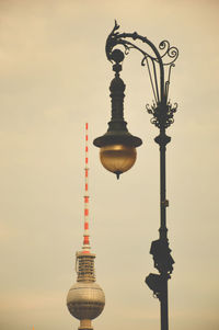 Low angle view of street light against building