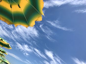 Low angle view of sun umbrella against sky