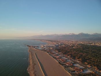 High angle view of buildings and sea against sky