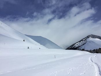 Scenic view of snow covered mountains against sky