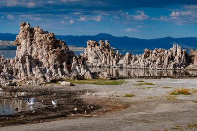 Panoramic shot of rocks on shore against sky
