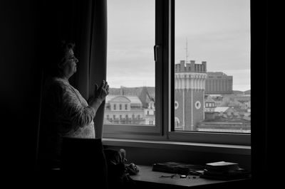 Woman looking through window