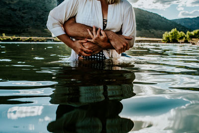 Reflection of man in lake