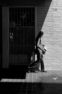 Side view of woman walking on footpath