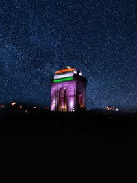 Low angle view of illuminated building against sky at night