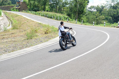 Man riding motorcycle on road