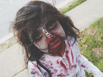 Close-up portrait of girl with spooky face paint