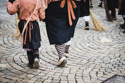 Low section of people walking on street