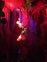 Low angle view of illuminated red rock formations at night