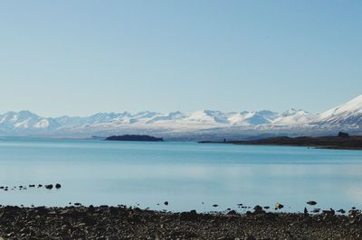 Scenic view of lake against clear blue sky