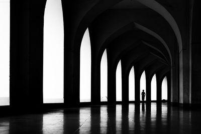 Low angle view of silhouette man standing in building