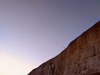 Low angle view of mountain against clear blue sky