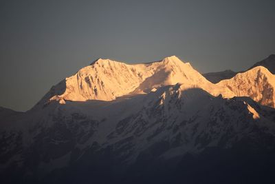 Scenic view of snowcapped mountains against clear sky