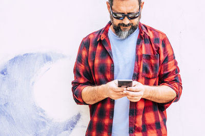 Midsection of man using mobile phone