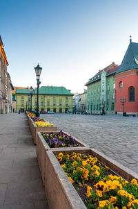 Street amidst buildings against clear sky