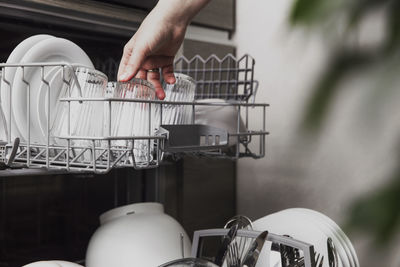 Loading dished to, empty out or unloading from open automatic stainless built-in dishwasher machine