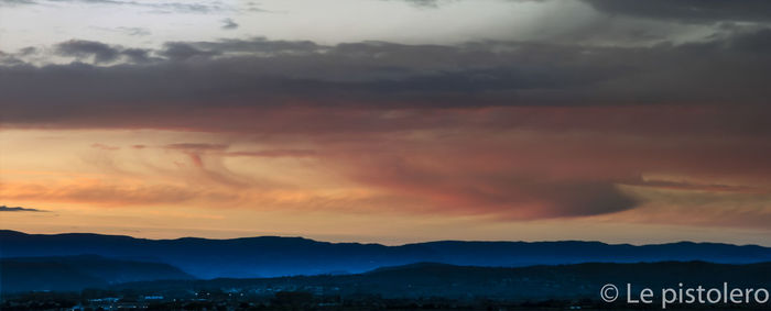 Scenic view of mountains against sky at sunset