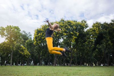 Fit young woman jumping in the park