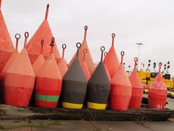 Close-up of multi colored umbrellas against sky