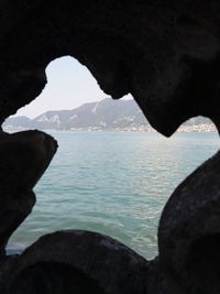 Scenic view of sea seen through cave