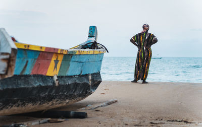 African woman in long suit standing by the shore in keta ghana west africa