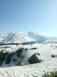 Scenic view of mountains against clear blue sky