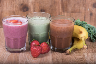 Close-up of fruits with drink on table