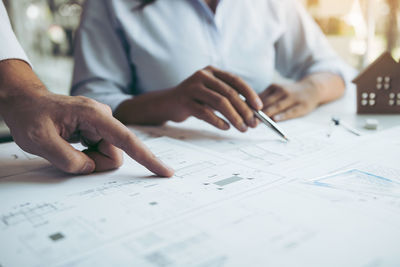 Close-up of man working on paper