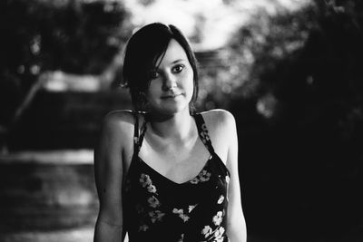 Portrait of smiling beautiful woman in yard