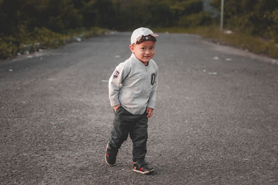 Portrait of young man walking on road