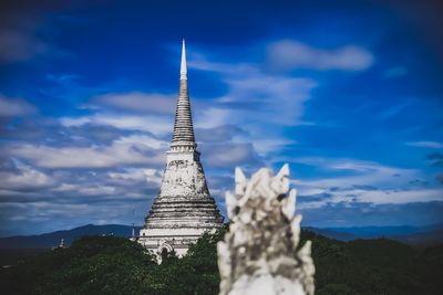 Low angle view of temple building against cloudy sky